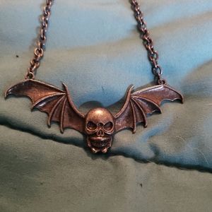 Skull with bat wings necklace